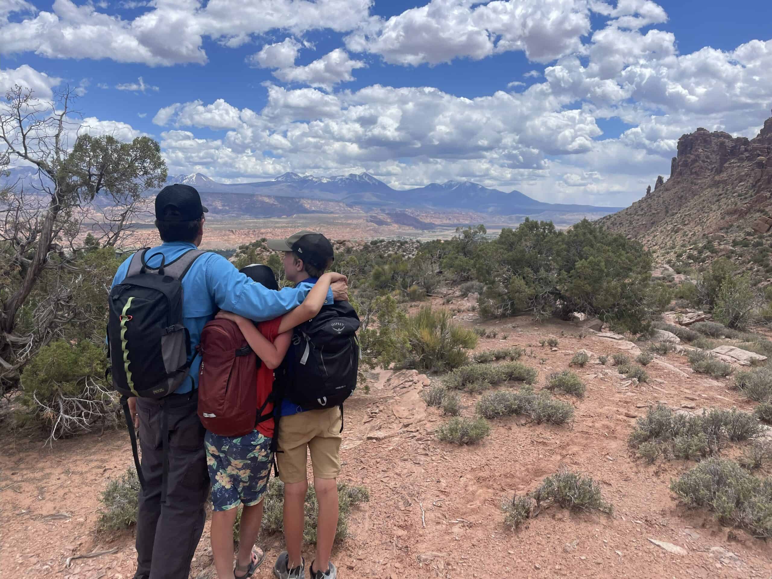 A father and two children at a canyon overlook