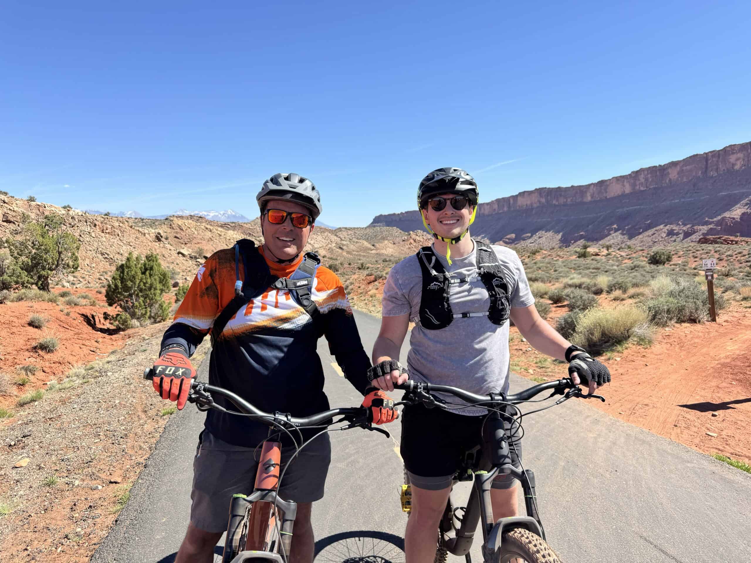 A father and son mountain biking together