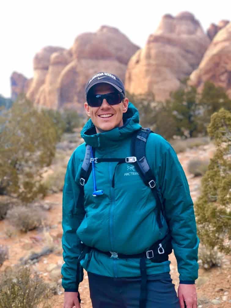 John Bishoff, founder of PathForgeXP, hiking through the red rock landscape near Moab, Utah.